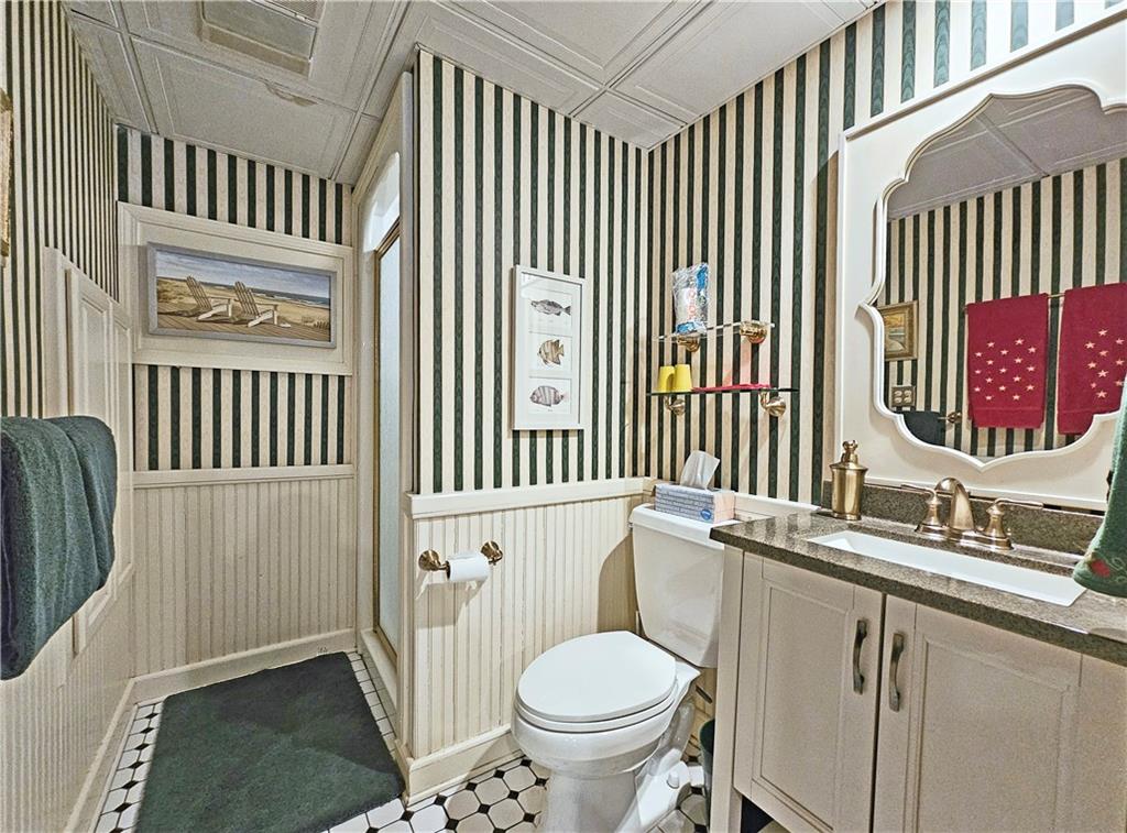 Bathroom featuring tile floors, vanity, and toilet
