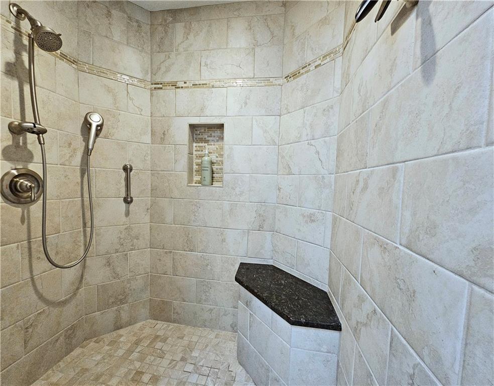 Bathroom featuring tiled shower