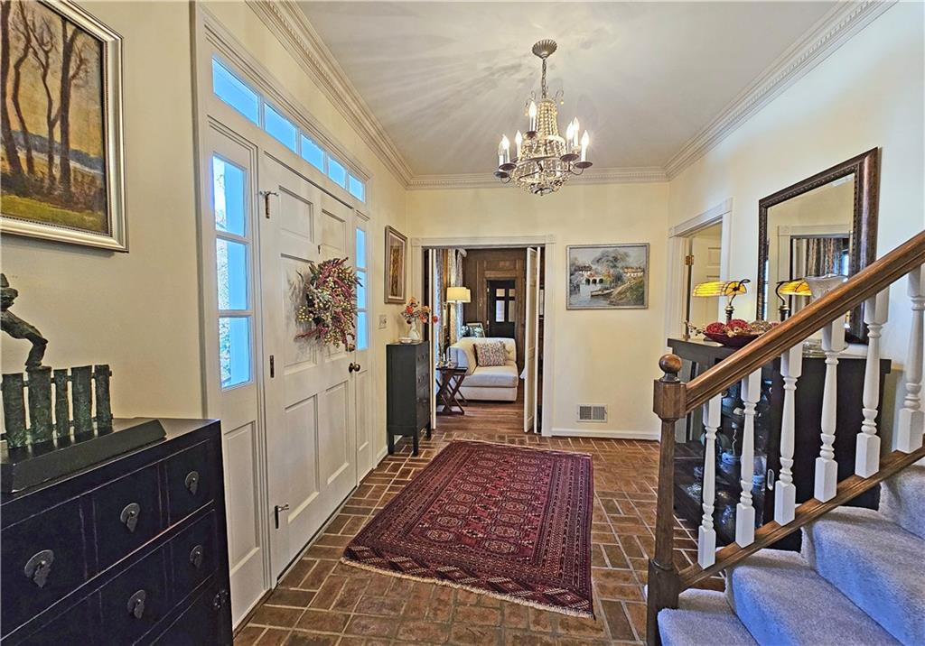 Foyer featuring a chandelier and ornamental molding