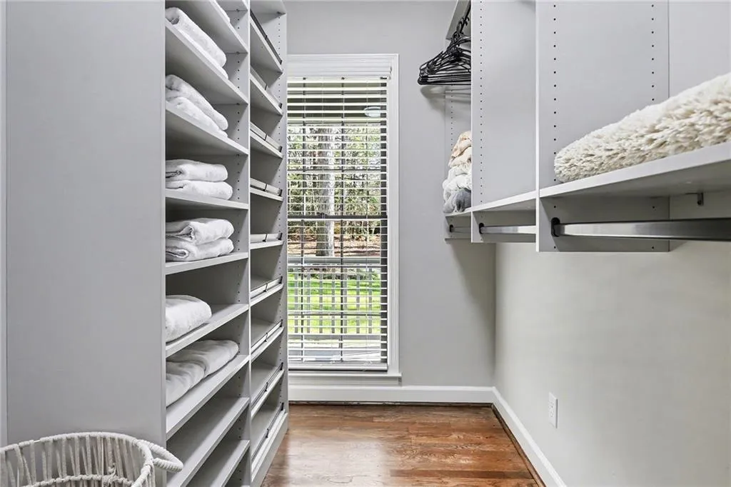 Walk in closet featuring wood finished floors