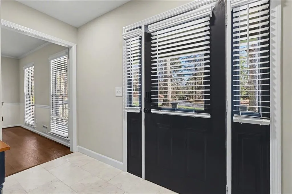 Entrance foyer featuring crown molding and baseboards