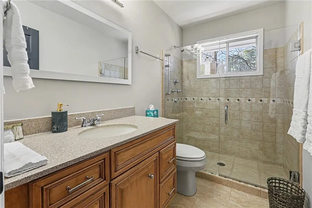 Full bathroom featuring vanity and a stall shower