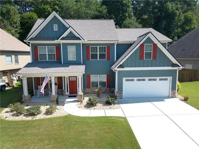 Two-story exterior with a covered front porch featuring stone-wrapped columns