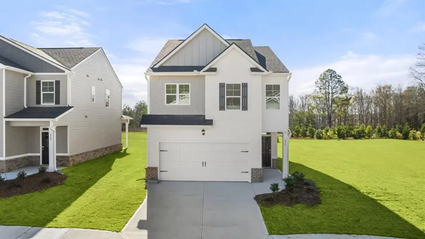Modern two-story residence with a two-car garage, stone accents, and a covered entry