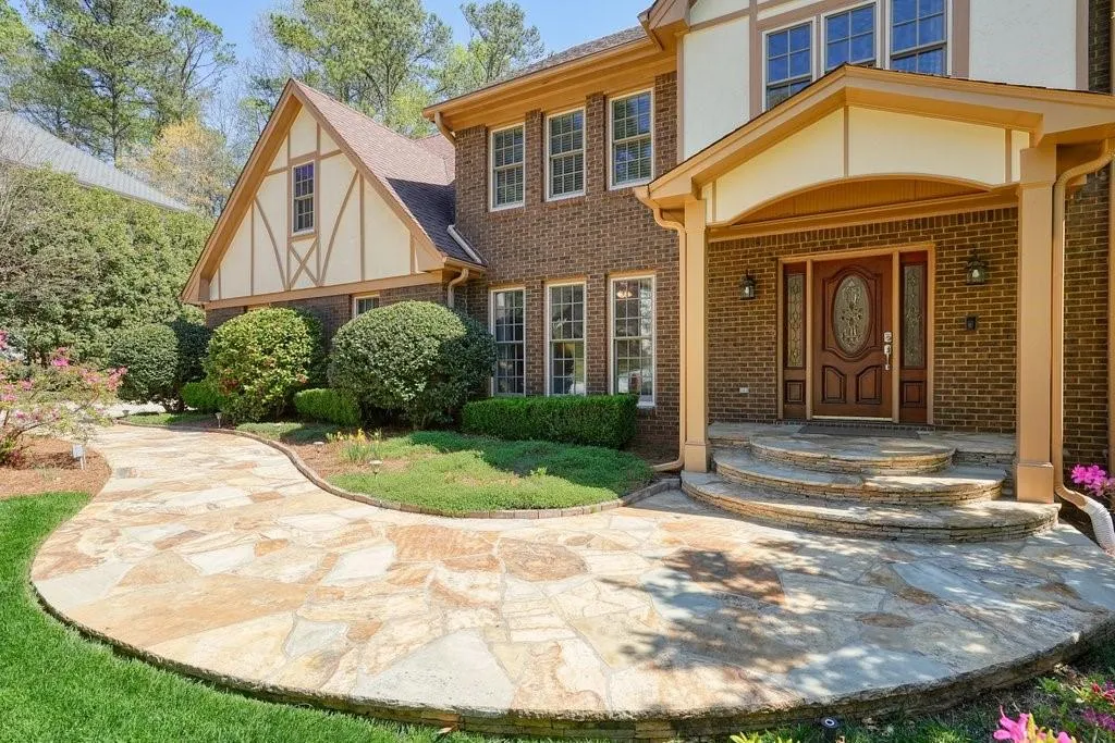 Entrance to property with stucco siding and brick siding