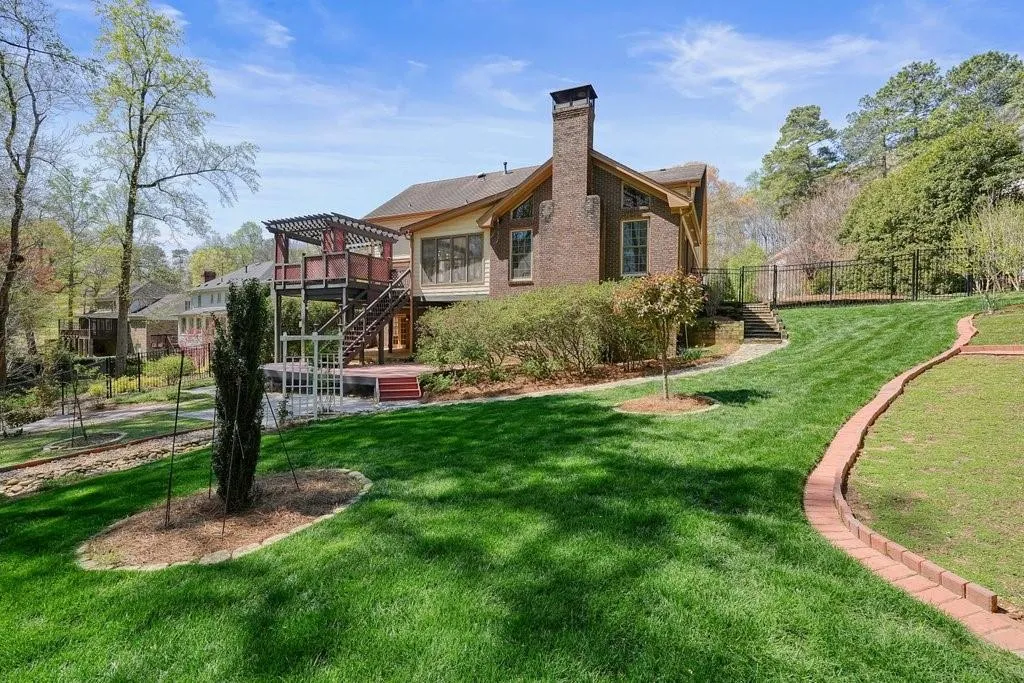 Rear view of property with stairs, a chimney, fence, a pergola, and a yard