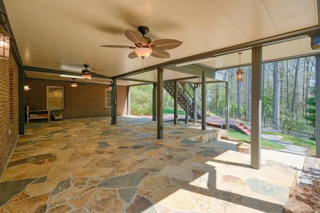 View of patio with fence and ceiling fan