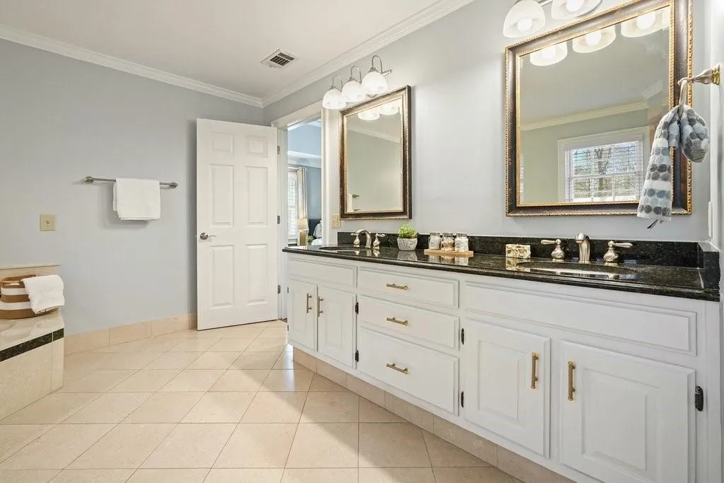 Full bathroom featuring tile patterned floors, a sink, crown molding, and visible vents