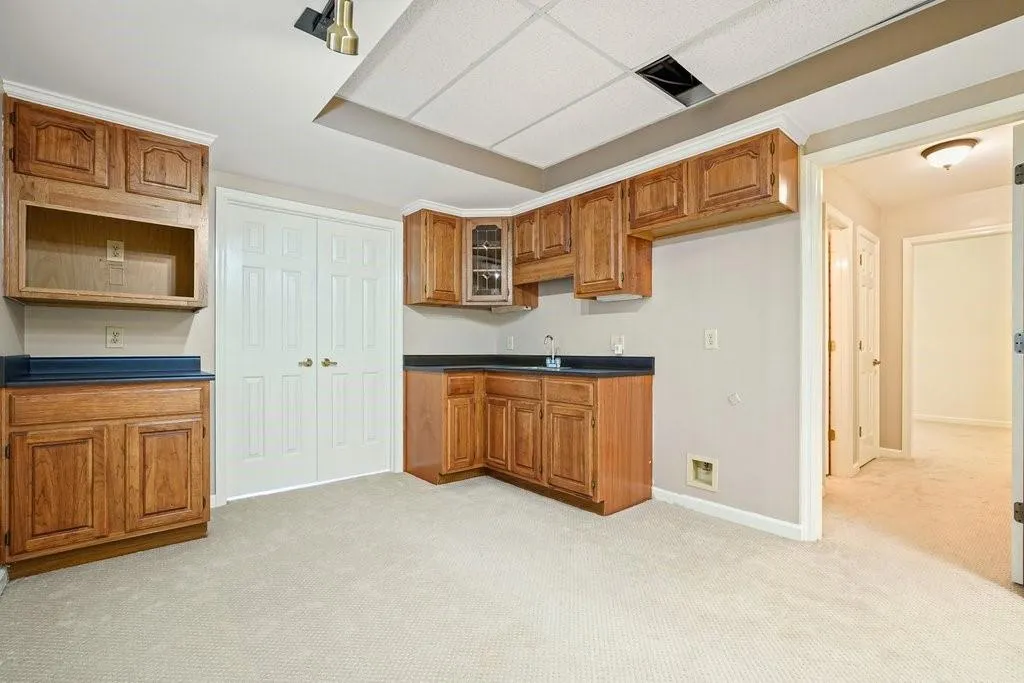 Kitchen with dark countertops and brown cabinets