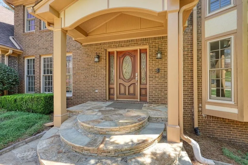 Doorway to property with brick siding