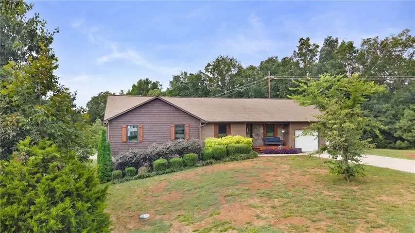 Charming ranch-style home set on nearly an acreounds with mature landscaping