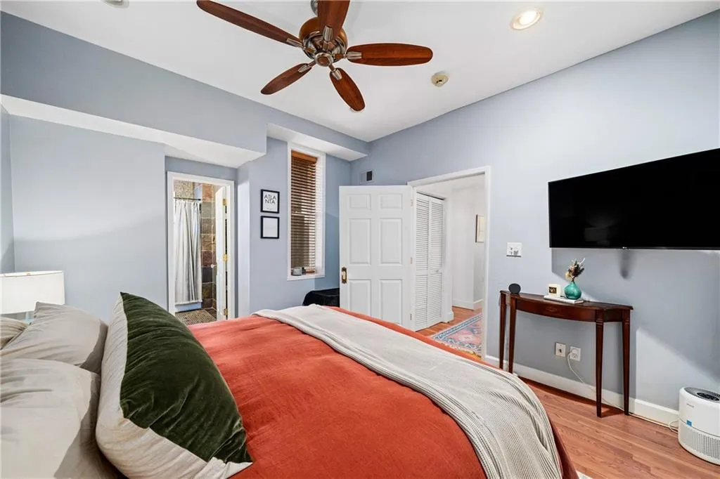Bedroom featuring wood finished floors, ceiling fan, and recessed lighting