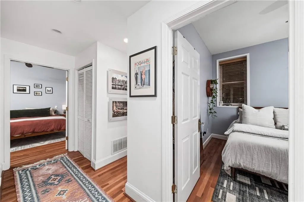 Bedroom featuring wood finished floors and a closet