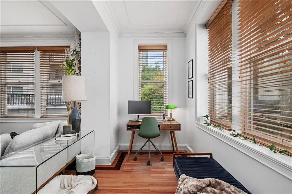 Home office featuring light wood-style floors and crown molding