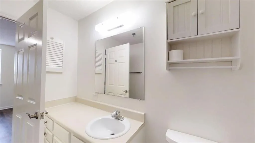 Half bath featuring vanity and toilet