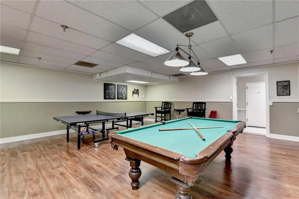 Recreation room featuring a wainscoted wall, a paneled ceiling, and billiards