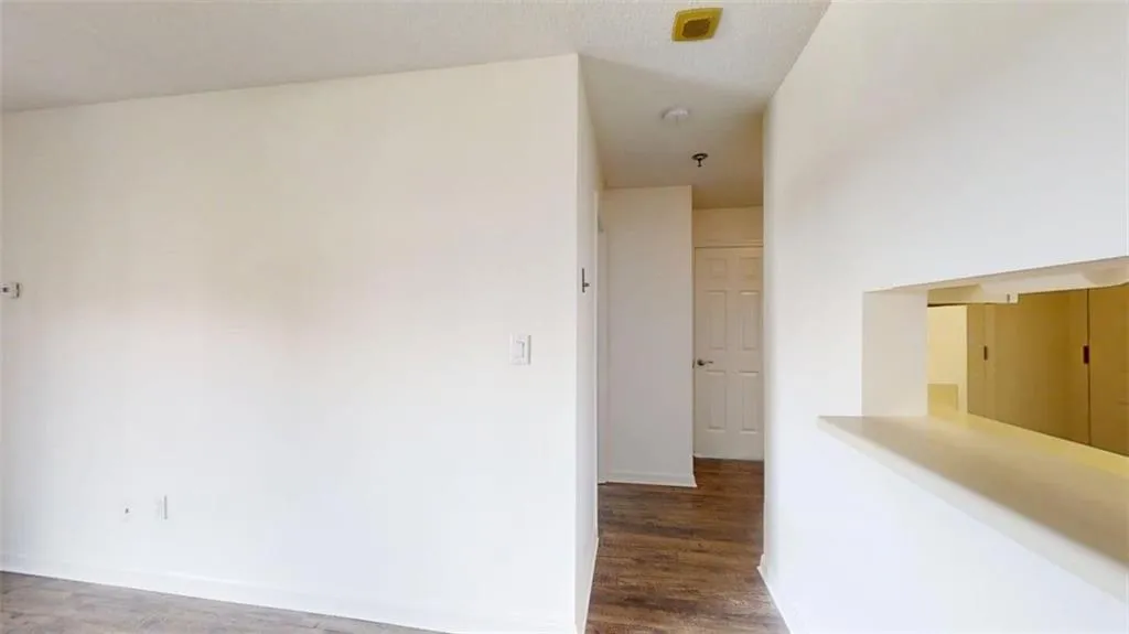 Corridor with dark wood finished floors and baseboards