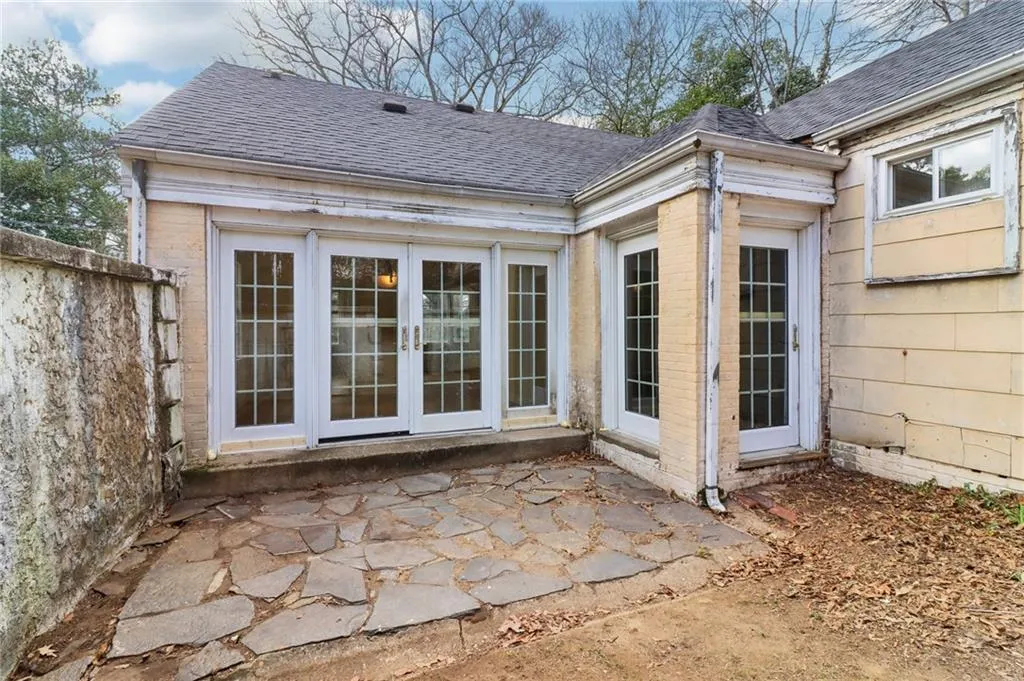 Back of property featuring a shingled roof, french doors, a patio, and fence