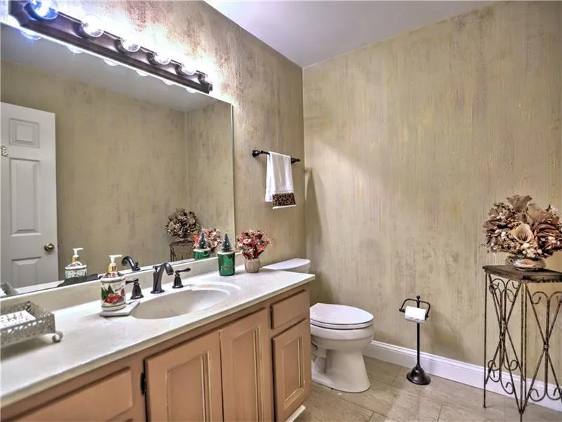 Bathroom featuring tile patterned floors, vanity, and toilet