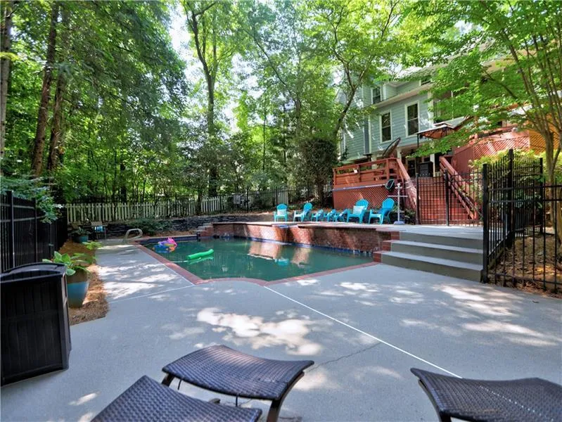 View of swimming pool featuring a patio and a deck