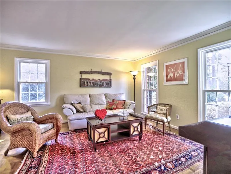 Living room featuring crown molding and hardwood / wood-style floors