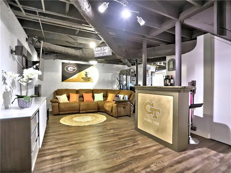 Basement with dark wood-type flooring and indoor bar