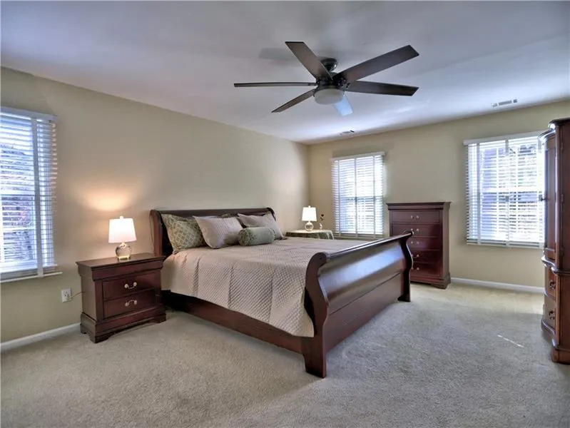 Bedroom featuring light colored carpet and ceiling fan