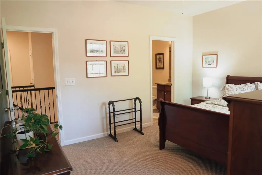 Carpeted bedroom with ensuite bathroom