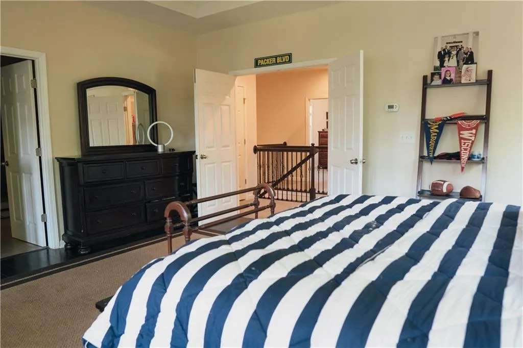 Bedroom with dark colored carpet