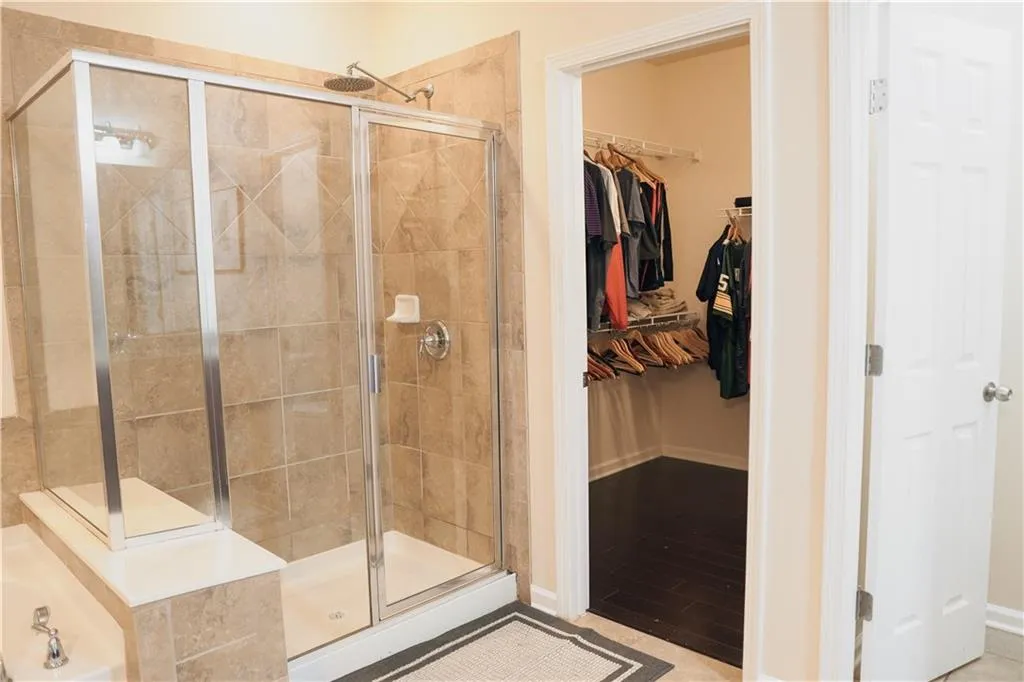 Bathroom featuring separate shower and tub and tile patterned flooring
