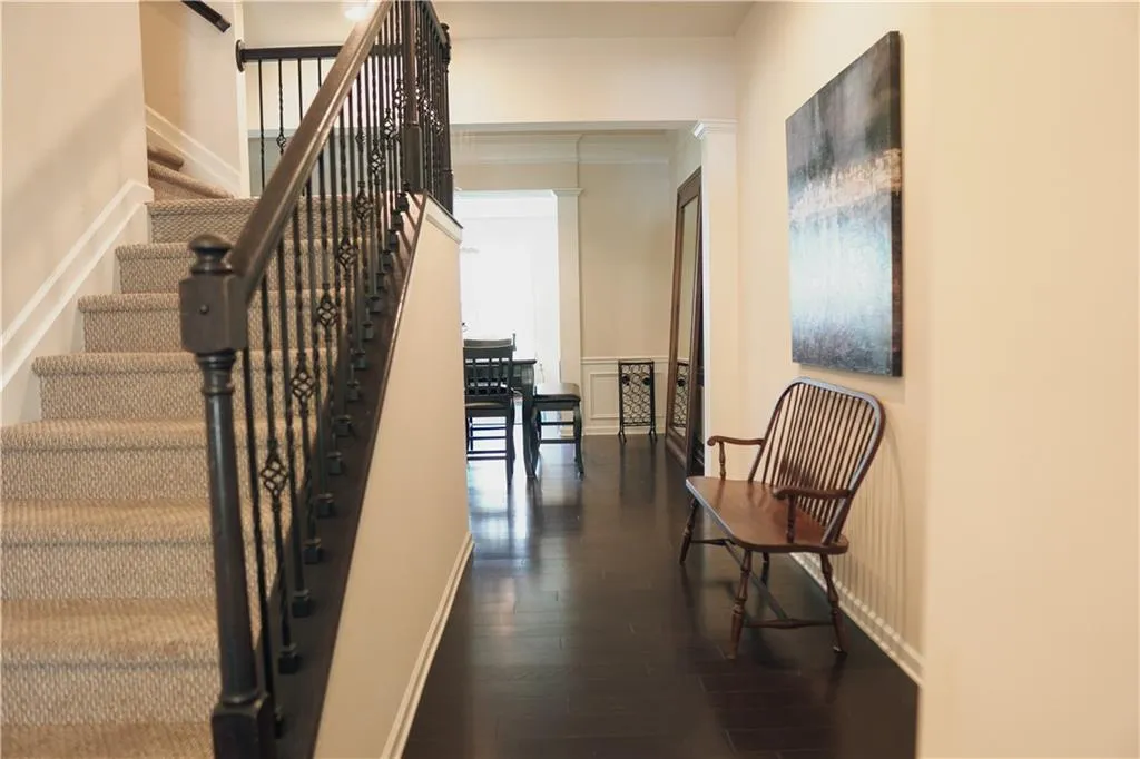 Stairs with dark hardwood / wood-style floors