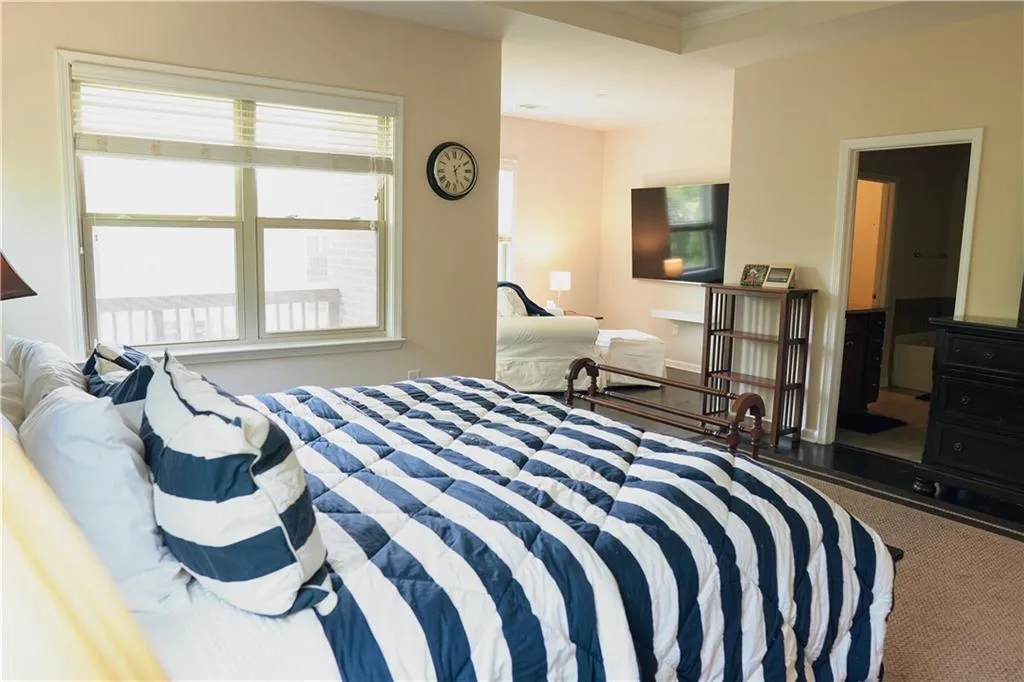 Carpeted bedroom with ornamental molding