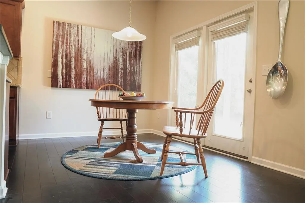 Dining area featuring dark wood-type flooring