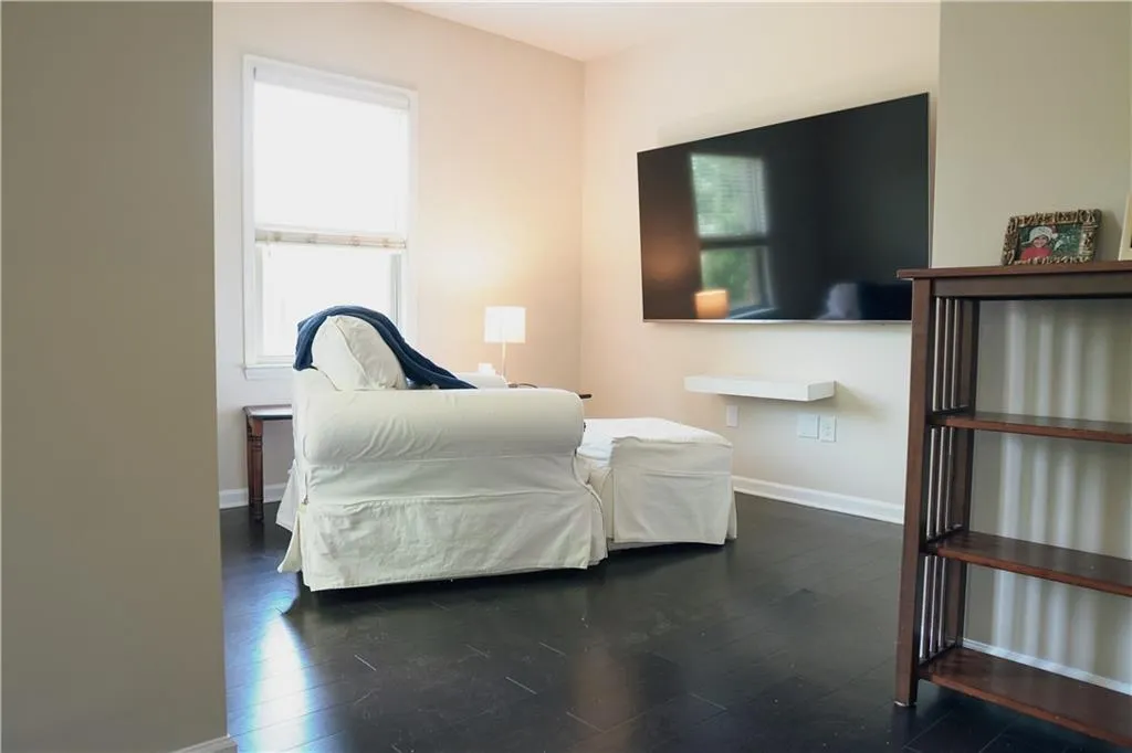 Bedroom with dark hardwood / wood-style floors
