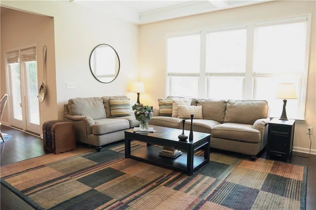 Living room featuring dark hardwood / wood-style flooring and crown molding