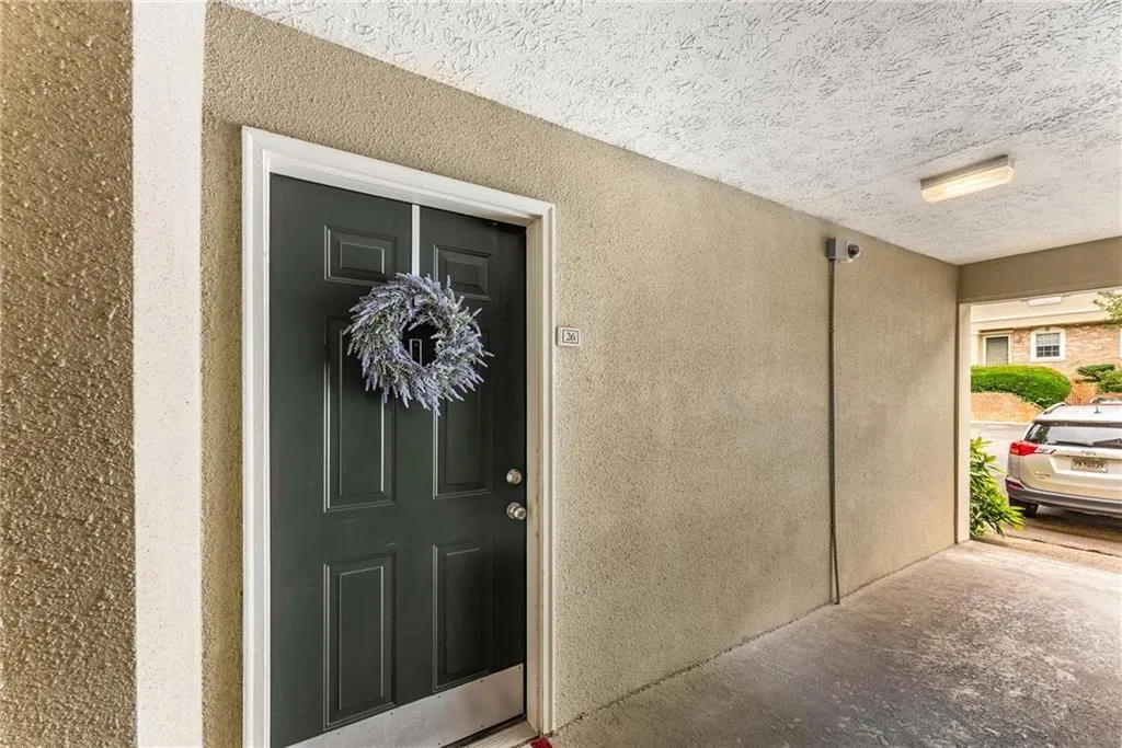 Property entrance featuring stucco siding