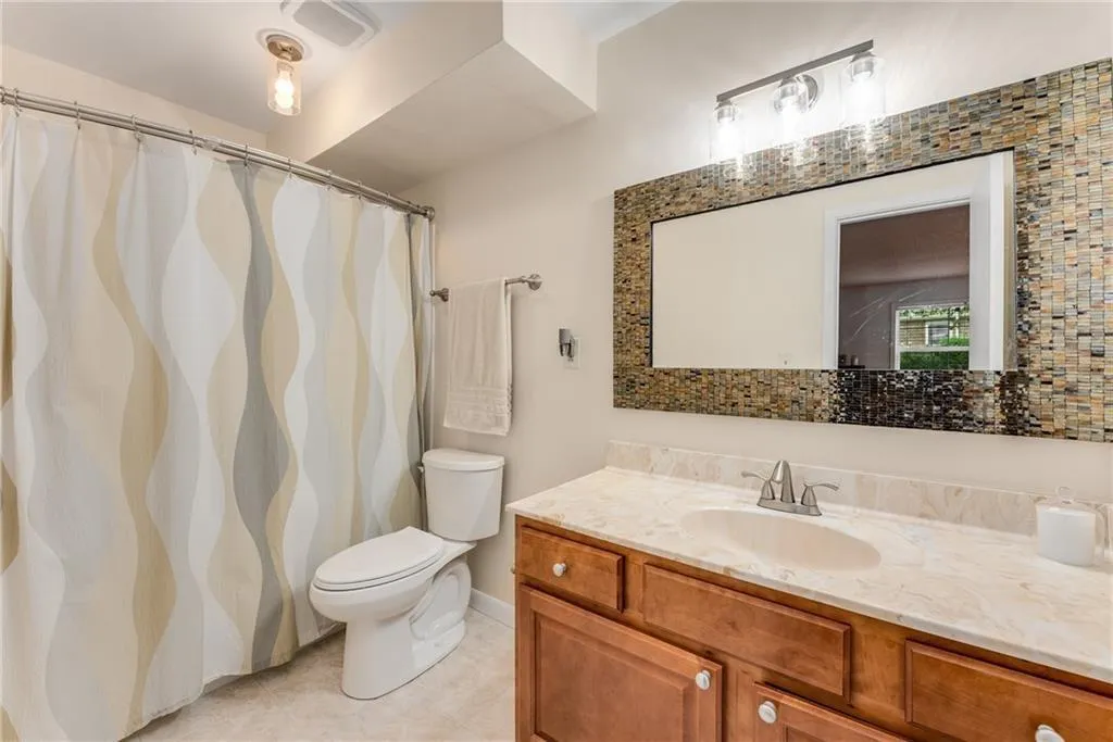 Bathroom with vanity and a shower with shower curtain