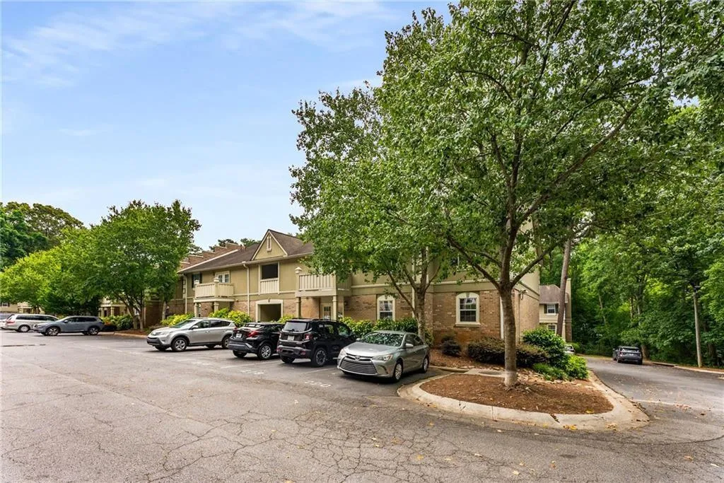 View of property featuring uncovered parking