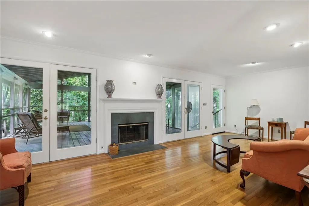 Family room with French doors exiting a large screened in porch