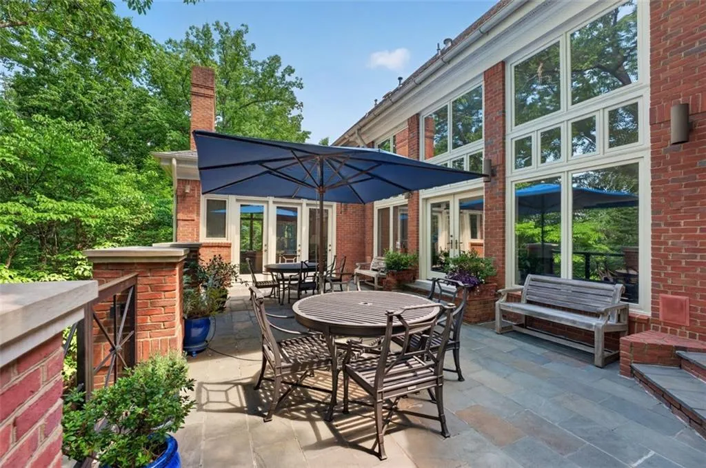 Expansive exterior patio featuring bluestone paving and brick construction