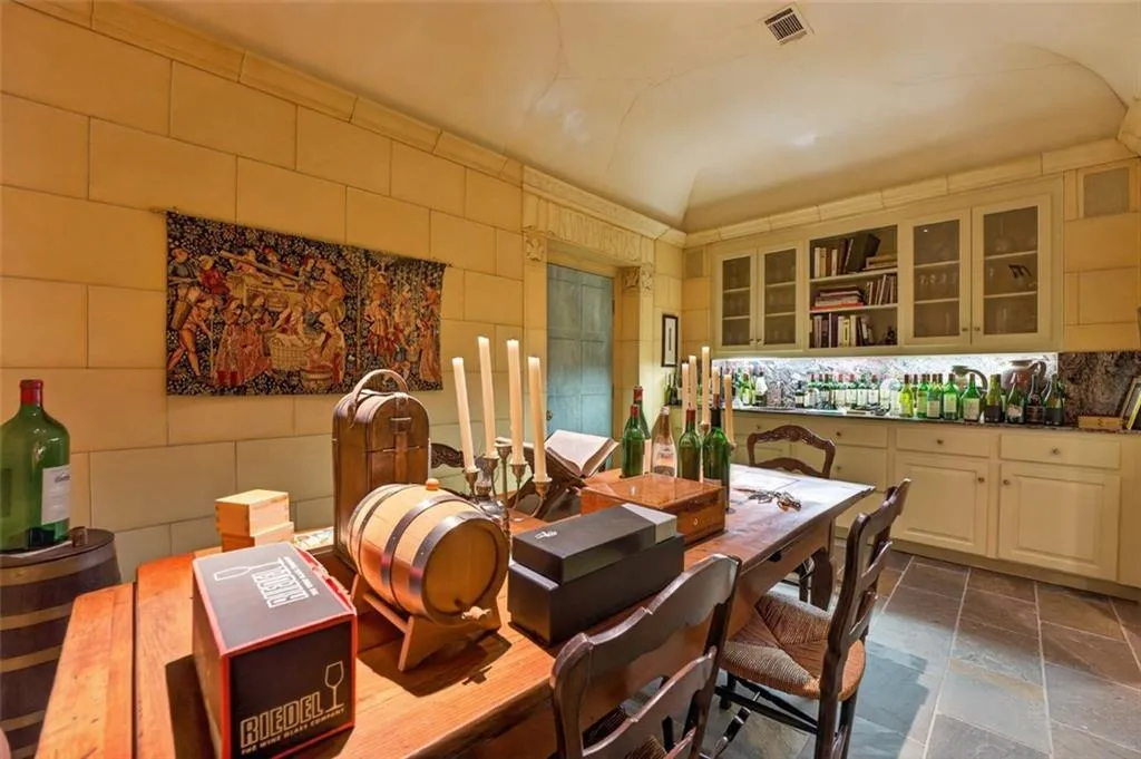 Stone tile flooring with a built-in cabinetry and glass-front upper cabinets