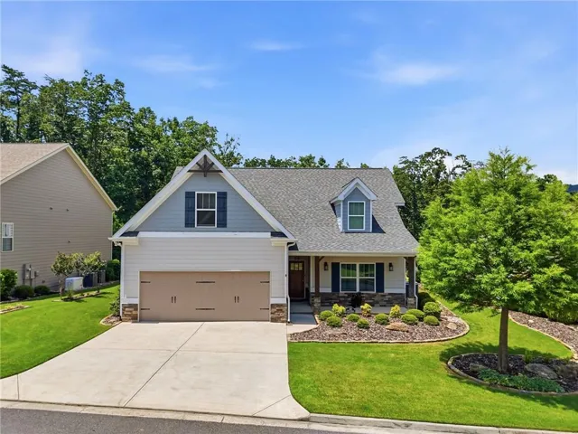 Craftsman-style exterior featuring a gray shingle roof and light-colored siding