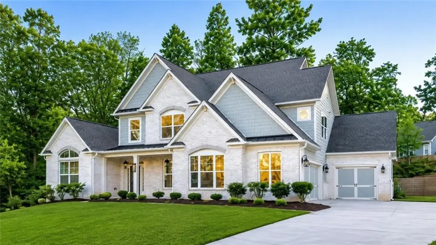 White brick and light blue siding exterior with dark shingle roofing