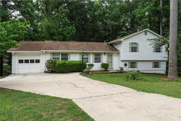 White siding exterior with a partial two-story design and attached single-car garage