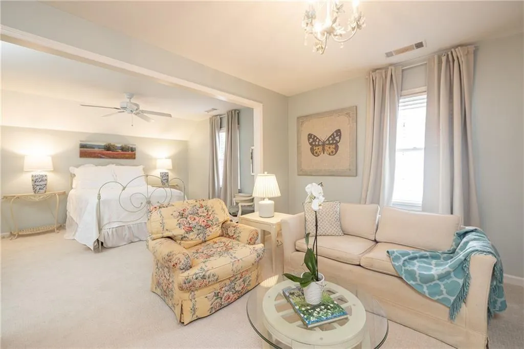 Bedroom featuring carpet flooring, suspended lighting, and vaulted ceiling