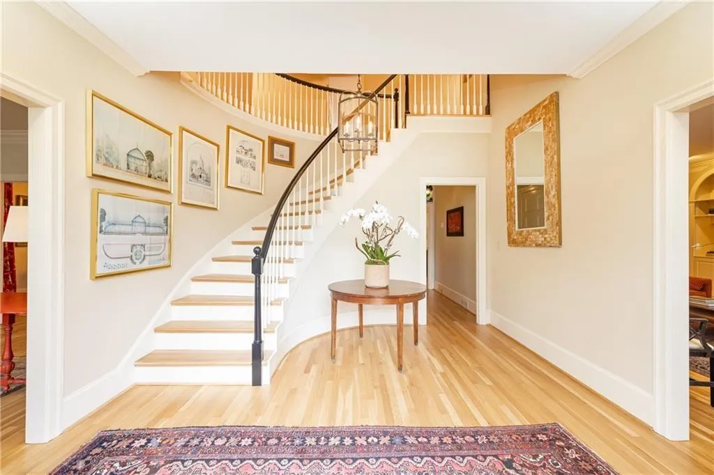 Foyer with light wood finished floors and ornamental molding