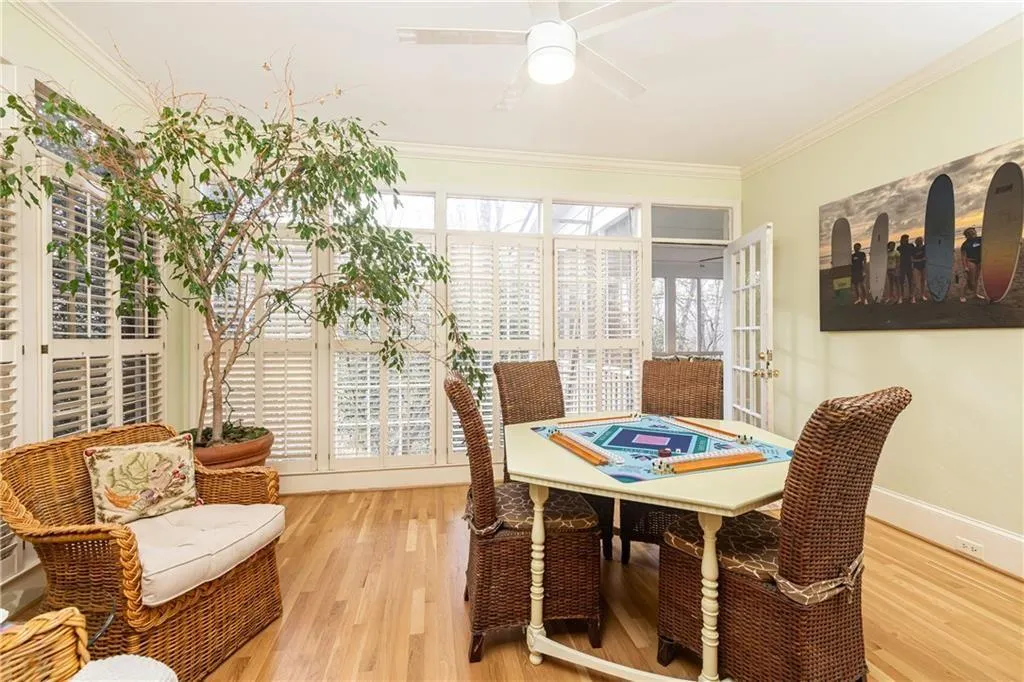 Dining area featuring crown molding, wood finished floors, and ceiling fan