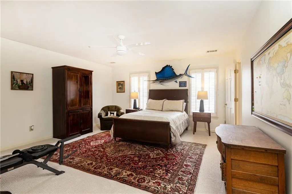 Bedroom featuring a ceiling fan and light carpet