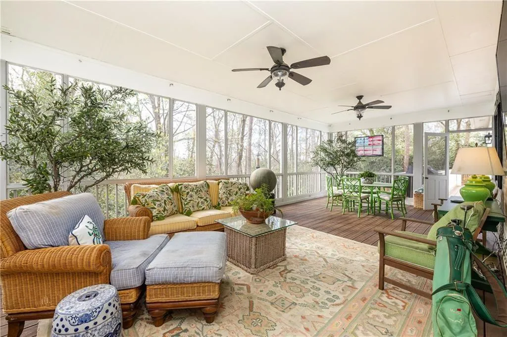 Sunroom with ceiling fan and outdoor lounge area