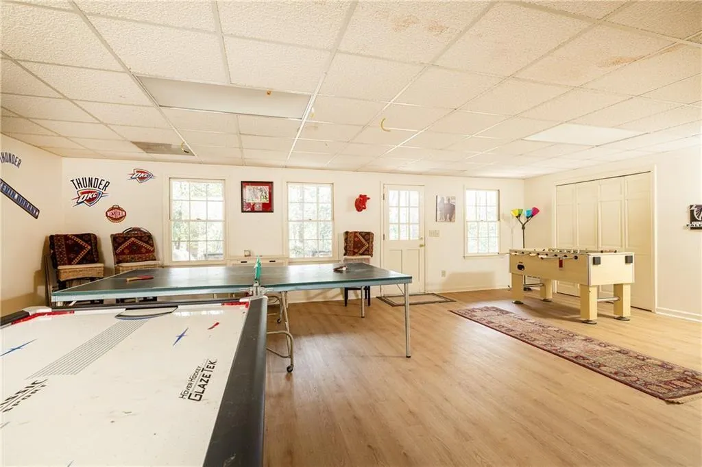 Rec room featuring light wood-style flooring and a drop ceiling